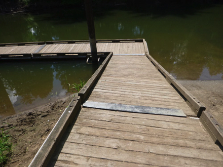 Wood ramp to wood dock – metal strip across dock – wood lip on ramp and dock – slope depends on water level